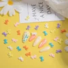 Kawaii resin bow nail charms on yellow background