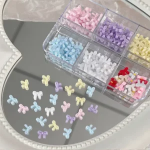 Round-head mini pastel bow nail charms shown in close-up with candy color mix