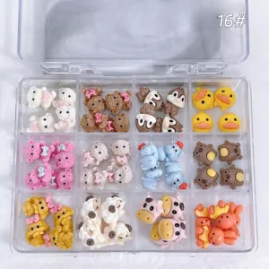 Knitted & Plush Animal Nail Charms arranged in a grid display case with assorted colorful resin pieces