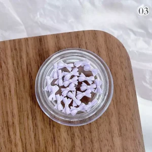 Lilac purple bow nail charms with pearl detailing and semi-gloss finish