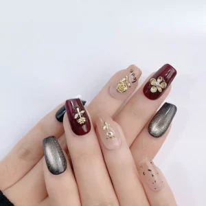 Golden floral nail charms on matte and glossy nails in cohesive neutral palette