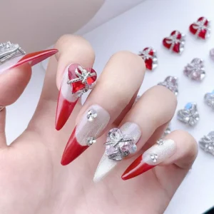 Red and pink glam nail charms on luxury silver gradient nails