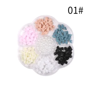 Matte resin bow nail charms with neutral tones and central pearl accents
