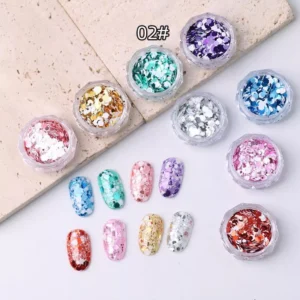 Mixed metallic and iridescent glitter nail flakes in silver, blue, green, and gold tones