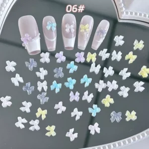 Glossy holographic bow charms in soft pastel palette