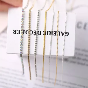 Assorted metal nail chains in gold, silver, and rhinestone finishes displayed on a card