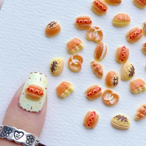 Macro view of 3D bread nail charms on fingertips