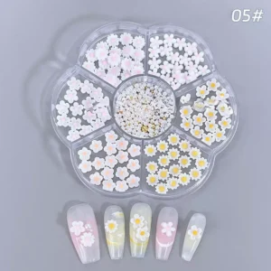 Resin daisy nail charms with yellow centers and rhinestone accents