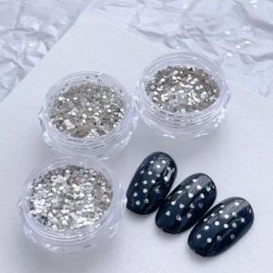 Mini Glitter Nail Sequins in heart, star, and dot shapes with black base nail display