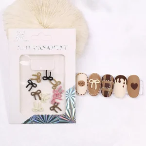Mini matte resin bow nail charms in brown, black, pink, and ivory with cute packaging