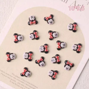 Minnie Mouse-inspired nail charms with red bow and black ears