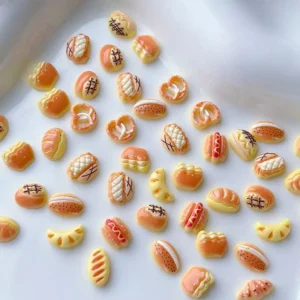 Mixed Cartoon Bread Nail Charms laid flat on ceramic tray