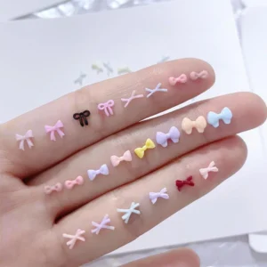 Multicolor Sweet Resin Bow Nail Charms in various styles displayed on hand