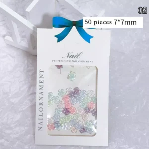 Box of resin flower nail charms, including translucent pastel petals in 7mm size
