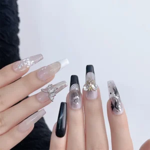 Monochrome butterfly nail art using zircon charms on model hands