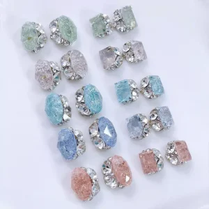 Clear rhinestone-accented nail charms in multiple colors and shapes