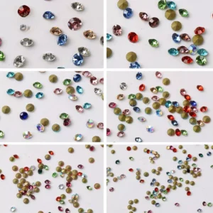 Multicolored rhinestone set for nail art with stones in vibrant shades of red, green, and blue, neatly separated by size.