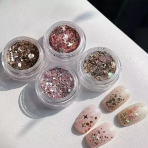 Multi-effect sparkle nail sequins in four jars with finished nail art