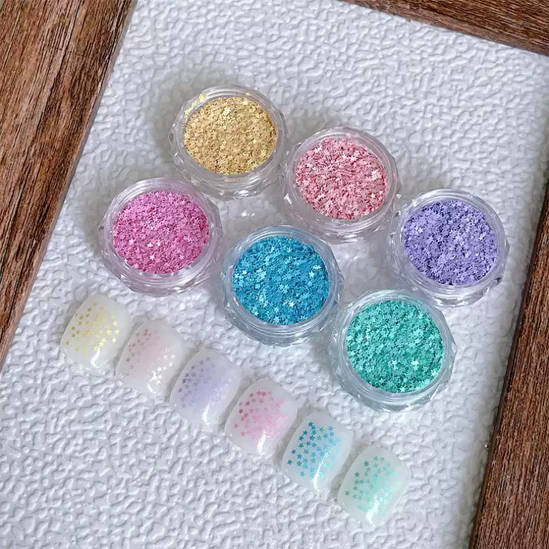 Various glitter colors including gold, pink, blue, and purple for nail decoration.