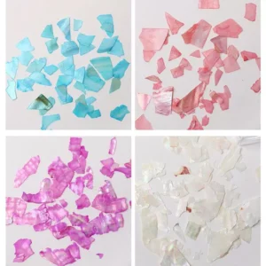 Close-up of multicolor shell nail flakes in blue, pink, purple, and white shades