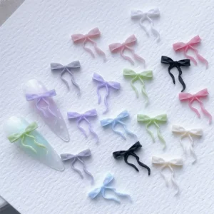 Collection of pastel and black bow ribbon nail charms for nail art