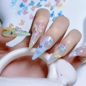 Butterfly nail charms applied to gradient pastel manicures