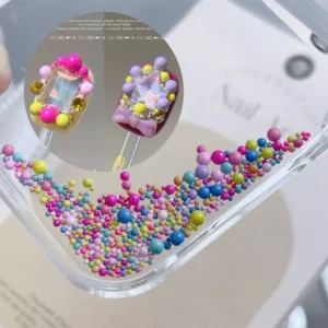 Multi-size rainbow caviar beads on palette with crystal and bow nail embellishment
