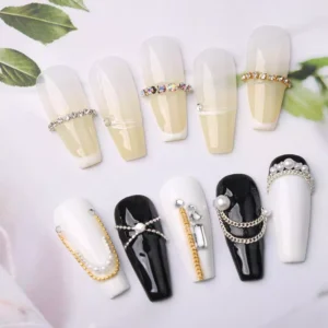Nail art designs using rhinestone and pearl chains on black and white gel nails
