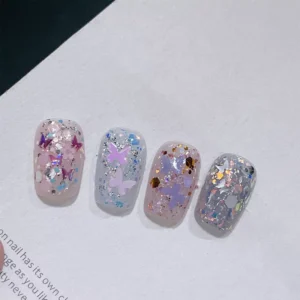 Glitter nail swatches with iridescent butterflies and pastel flakes