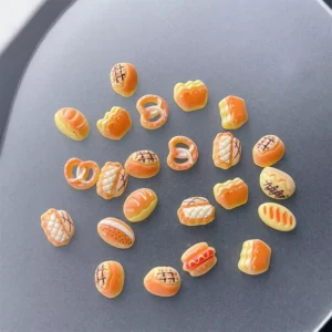 Bright daylight view of 3D Cartoon Bread Nail Charms with realistic finish