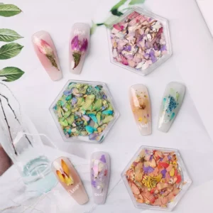 Natural dried flower nail decorations in hexagon containers with floral nail art
