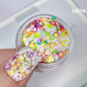 Neon multicolor circle sequins in yellow, pink, and orange for vibrant nail art