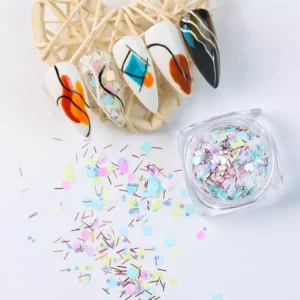 Close-up of pastel holographic sequins spilled with sample nail design