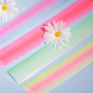 Unrolled pink, mint, and yellow ombré foil strips for nail transfer