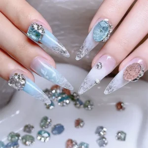 Rhinestone-adorned stiletto nails with pastel blue and white gradient