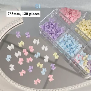 Assorted pastel mini bow nail charms in pink storage box, 7x5mm