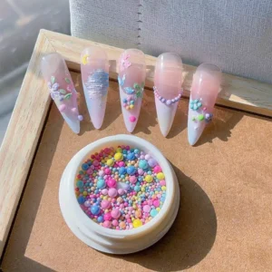 Dopamine caviar beads applied on nail tips in creative pastel floral design