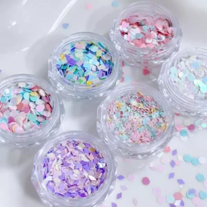 Nail art glitter jars with colorful confetti pieces in various shapes