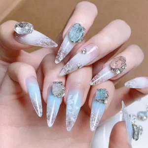 Elegant stiletto nails with pastel gradient and rhinestone embellishments