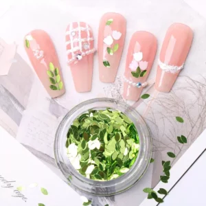 Green pastel leaf glitter flakes with spring-themed floral nail design