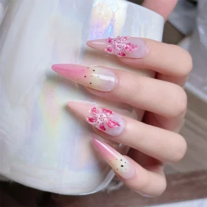 Pastel lily stickers on nails holding iridescent mug