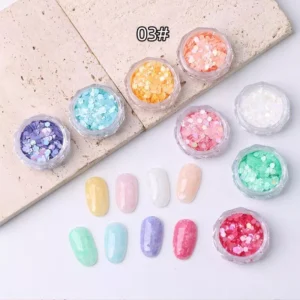 Pastel holographic glitter flakes set with soft iridescent finishes for nail design