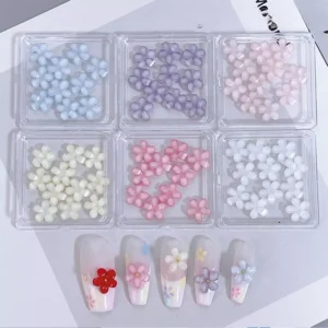 Mixed pastel flower nail charms in blue, lavender, pink, and ivory with demo nails