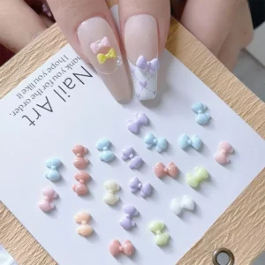 Assorted pastel 3D bow resin nail charms with glossy finish on display card