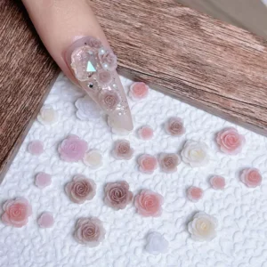 Flat lay of pastel rose nail charms for floral nail designs