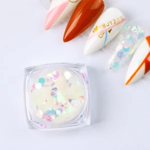 Round pastel holographic sequins in a clear container with nail tips