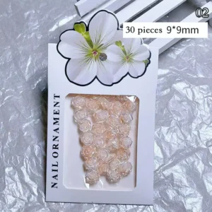 Peach-colored iridescent rose nail charms in 30-piece pack