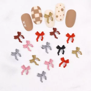 Mixed color matte bow nail charms with pearls scattered around nail art tips