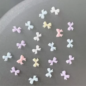 Pearlized macaron-style resin bows in lilac, yellow, blue and pink