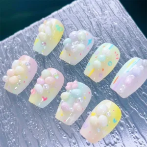 Pastel dopamine pearl pebble nail charms applied on gradient nail tips